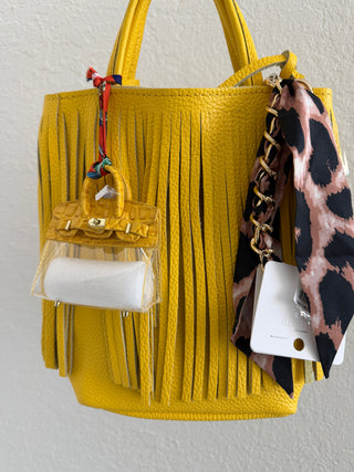 Yellow mini handbag keychain with a croc-embossed finish, gold hardware, and a Paris-inspired scarf accent.