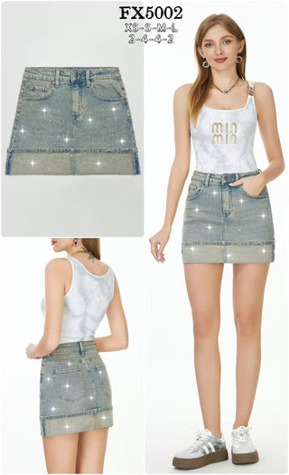 Denim mini skirt with allover sparkle embellishments, five-pocket styling, waistband detail, and a zip fly front.
