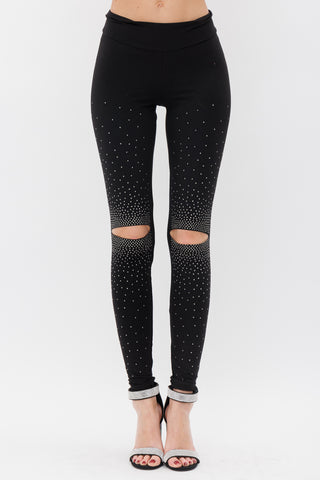 Black slim leggings with rhinestone fade embellishment and bold knee cut-out details.