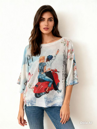 La Dolce Vita Ride Italian knit top with a relaxed draped shape, boat neckline, and romantic scooter city-scene graphic.