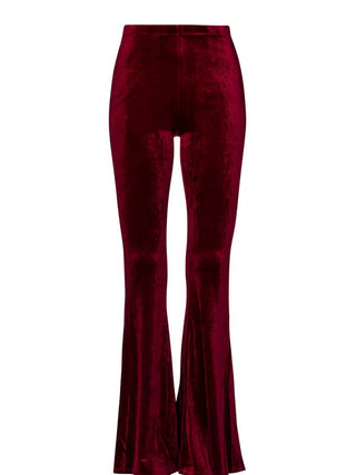 Burgundy velvet bell bottom flare pants with a high-rise waist and dramatic retro-inspired flare leg.
