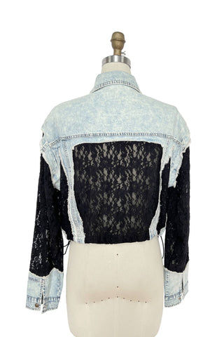 Denim jacket with lace overlay on a mannequin against a white background