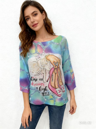 Colorful women’s graphic knit sweater featuring a high heels and handbag illustration with Chase Your Dreams text on the front.