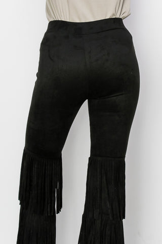 Black high-waisted flare pants with cascading tiered fringe from mid-thigh to hem.