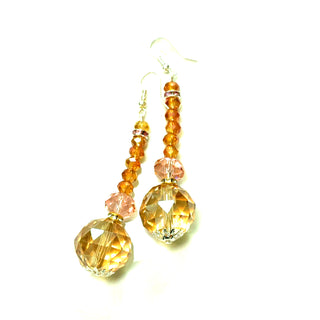 Beige and pink crystal drop earrings with faceted beads in an elongated cascade and a sterling silver hook post.