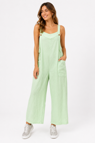 Soft mint linen wide leg jumpsuit with adjustable straps, button detail, and front pockets.