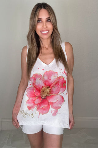 White sleeveless V-neck knit tank top with a pink flower graphic and subtle sparkle accents.