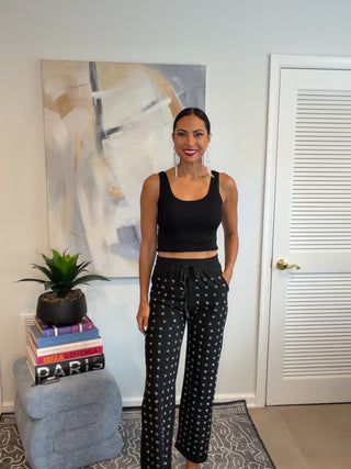 Black pull-on wide leg pants with sparkling embellishments across the front and an elastic waist.