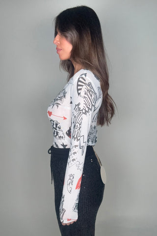 Person wearing a white shirt with black and red designs on a gray background