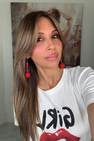 Red and clear gumball bead drop statement earrings hanging from sterling silver hooks.