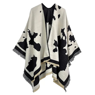 Black and white cow print draped poncho on a white background