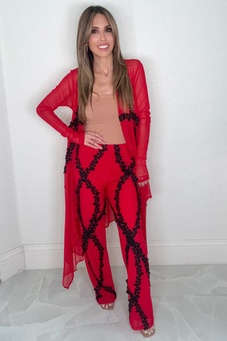 Red floral lace wide leg pants with a bold allover lace pattern and flowing wide leg silhouette.
