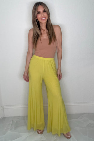 Yellow lime wide leg mesh pants with a bright color and flowy wide-leg silhouette.