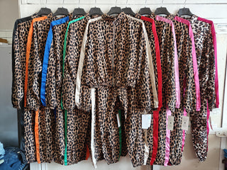 Leopard print zip-up track jacket with contrast stripe detailing, drawstring hood, and elastic cuffs.