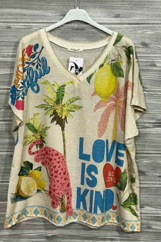 Pink Panther Graphic Knit Top with a soft neutral base, V-neckline, short sleeves, tropical graphics, slogan text, and a border print hem.