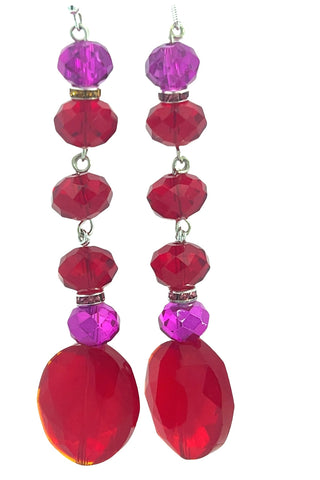 Pair of earrings with pink and red beads on a white background
