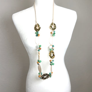 Long turquoise and white shell necklace with gold-tone details designed as a coastal statement jewelry piece.