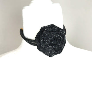 Black crystal flower choker necklace with a wide floral motif and sparkling embellished detail.