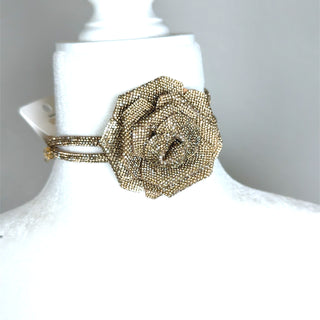 Gold crystal flower choker necklace with a dimensional floral centerpiece and three-row chain for elegant statement styling.