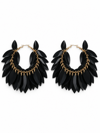 Black layered petal statement hoop earrings with gold-tone chain accents on a stark white background