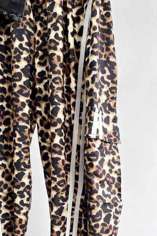Leopard print pants with white drawstrings on a light gray background