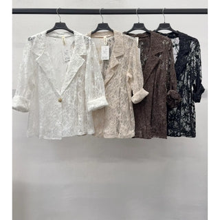 Four sheer floral lace blazers in ivory, mocha, chocolate, and black hang on a rack with notched lapels, rolled sleeves, and single button styling.