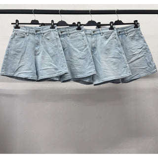 Light wash vintage-inspired denim shorts with a relaxed high-rise shape and classic five-pocket styling hanging on a rack.