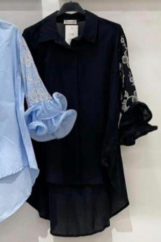 White button down top with a collared neckline, full button front, and embroidered ruffle sleeves.