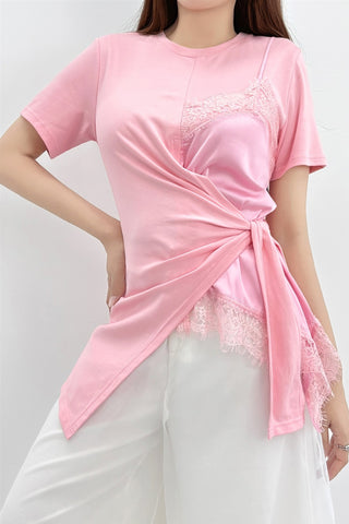 Pink lace layered wrap top with short sleeves, a draped overlay, and an asymmetric hem.