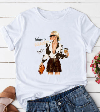White short sleeve graphic top with a bold cow print fashion illustration on the front.