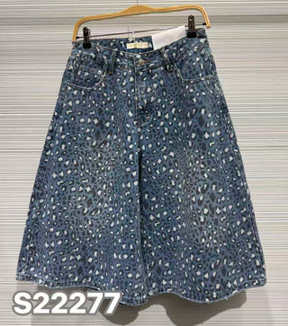 Denim blue leopard print Bermuda shorts with classic five-pocket styling and rhinestone embellishment hanging on a hanger.